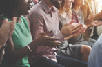 Audience members at an event clapping their hands